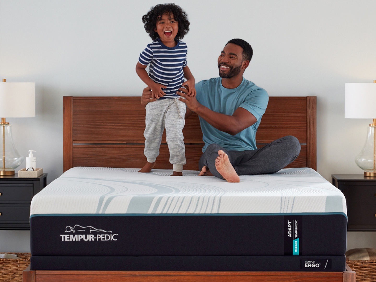 father and son sitting on a bed