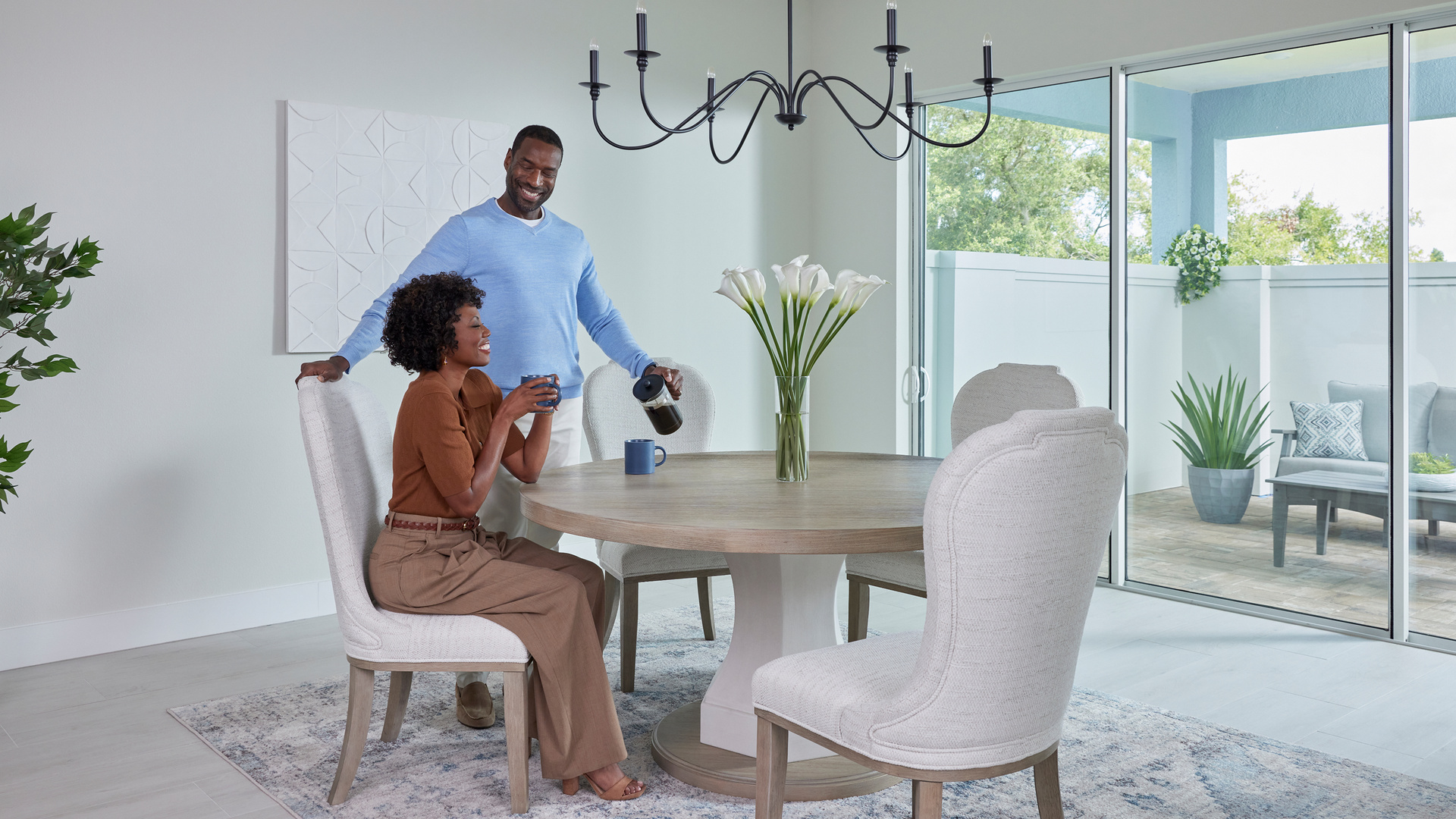 couple pouring coffee at dining table