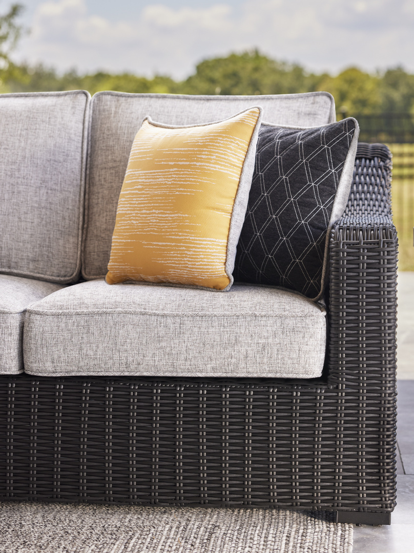 outdoor grey couch with colorful pillows
