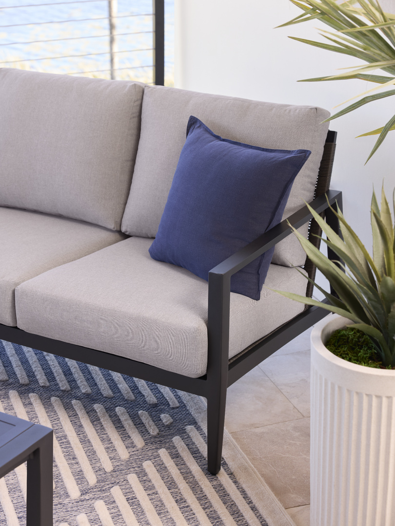 light grey chair with blue pillow