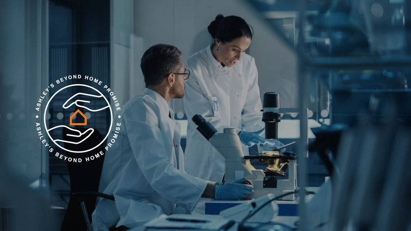 scientist in lab with Ashley logo