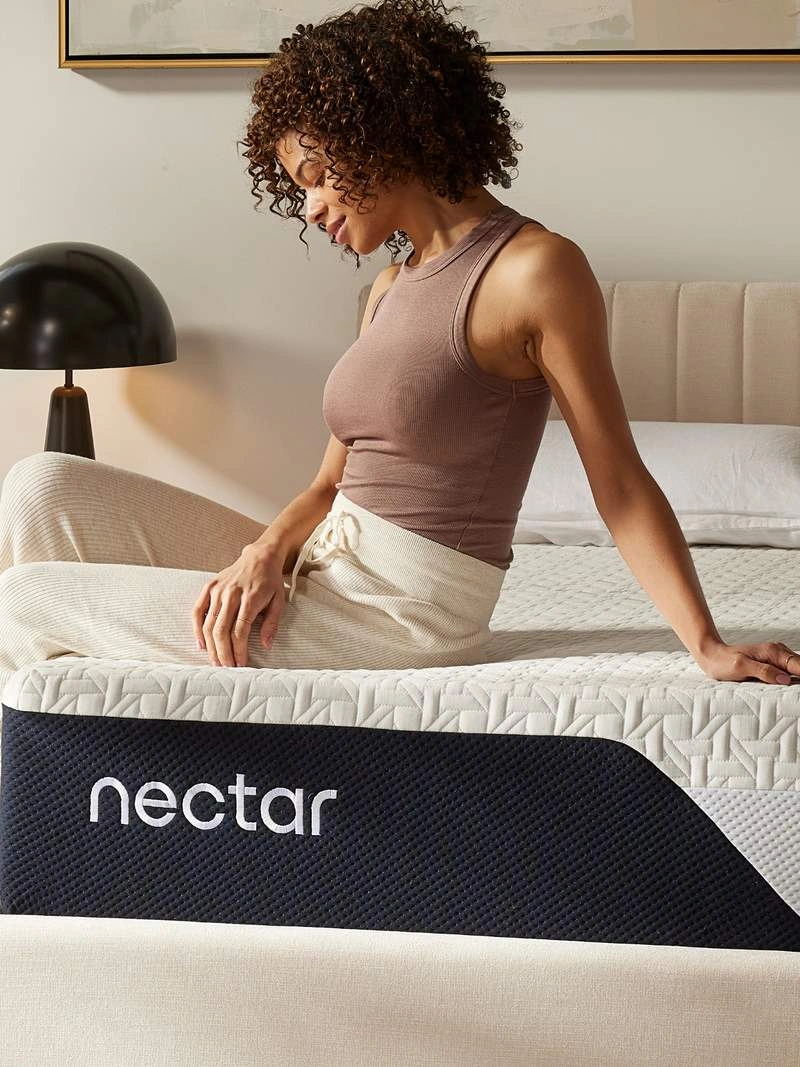 Woman sitting on a Nectar mattress