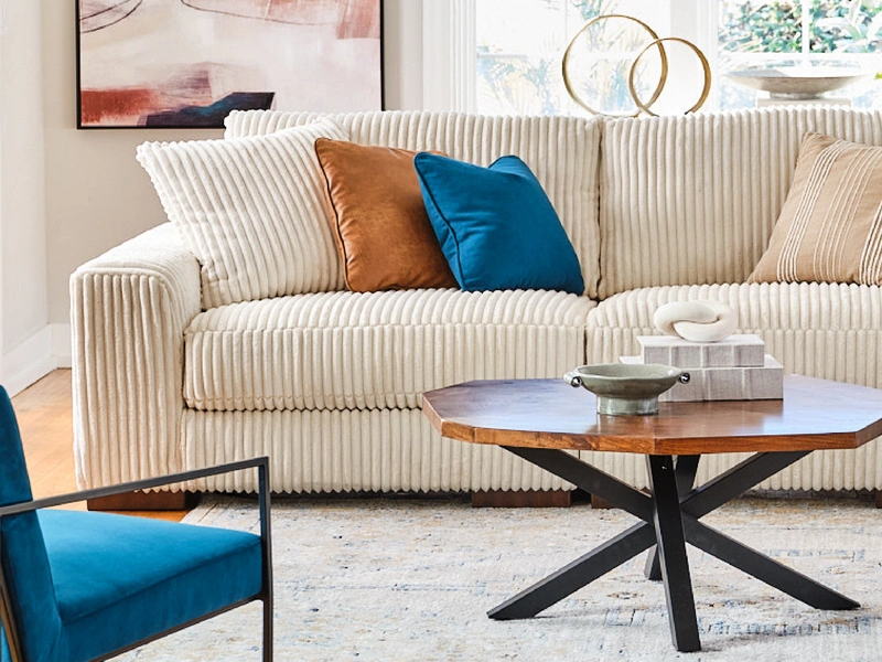 cream colored sofa with colorful accent pillows