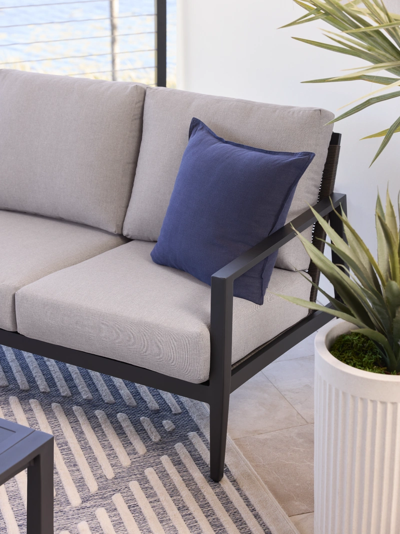 light grey chair with blue pillow