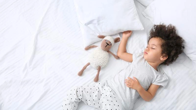 child sleeping in a bed