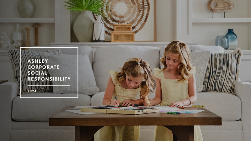 two young girls coloring on a wood table
