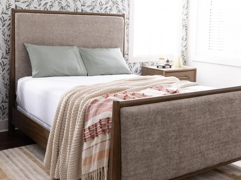 bed with sheets and a blanket